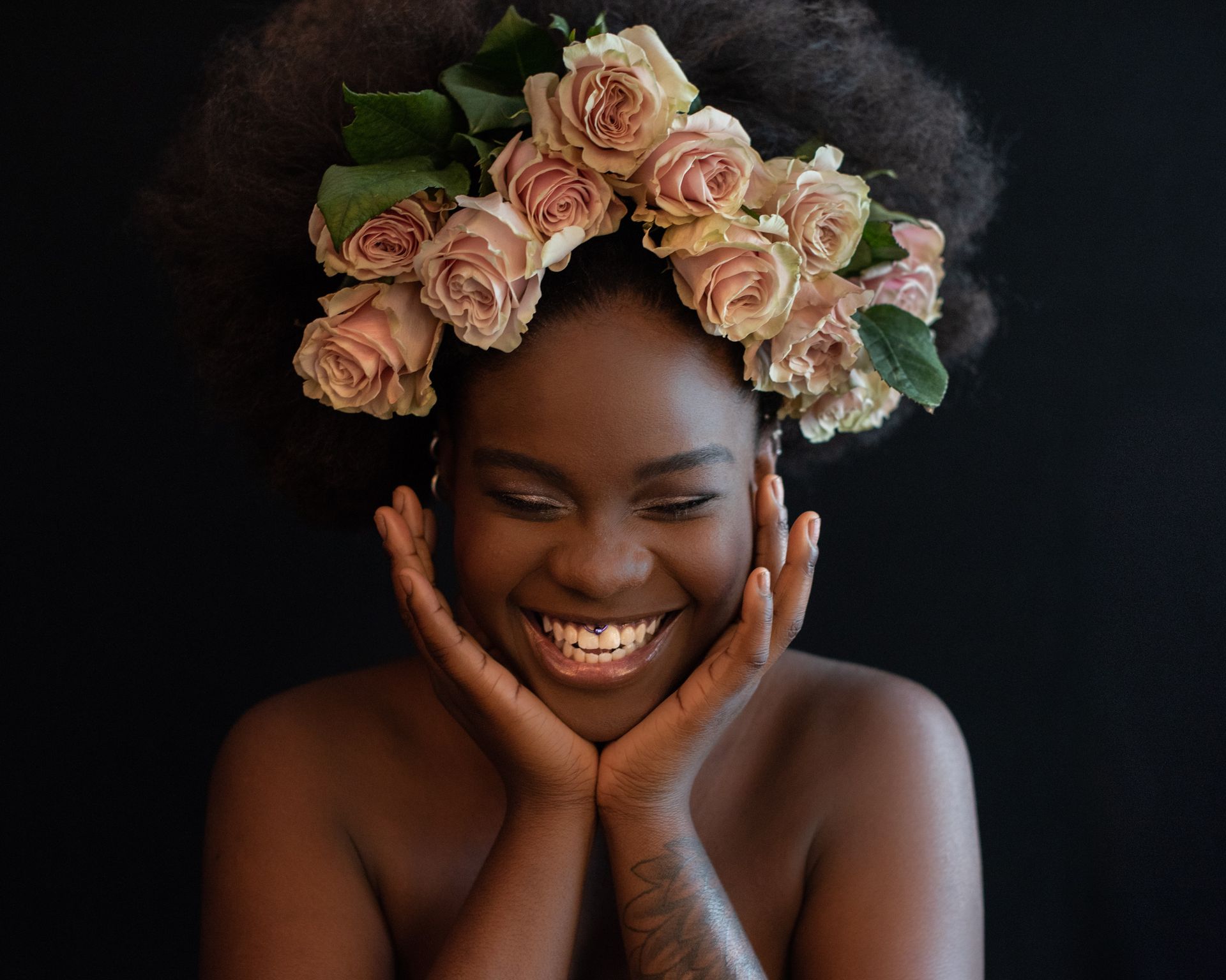 A woman with a flower crown on her head is smiling