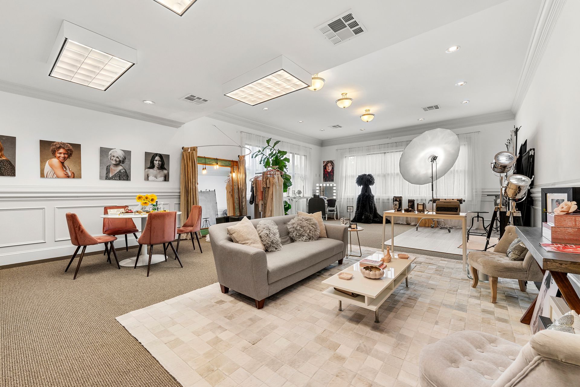 A living room with a couch , chairs , a table and a mirror.