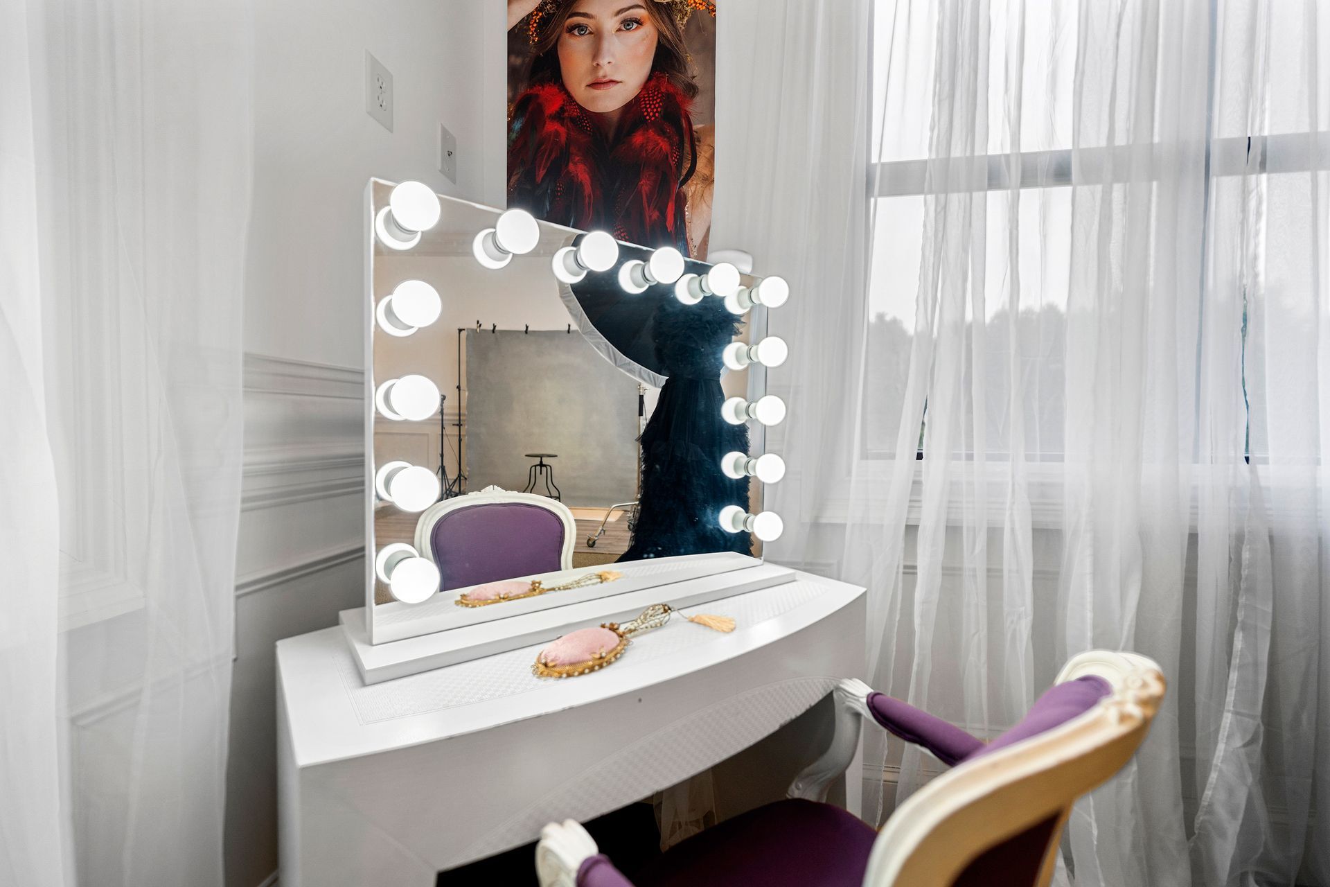 A vanity with a mirror and lights on it in a room.