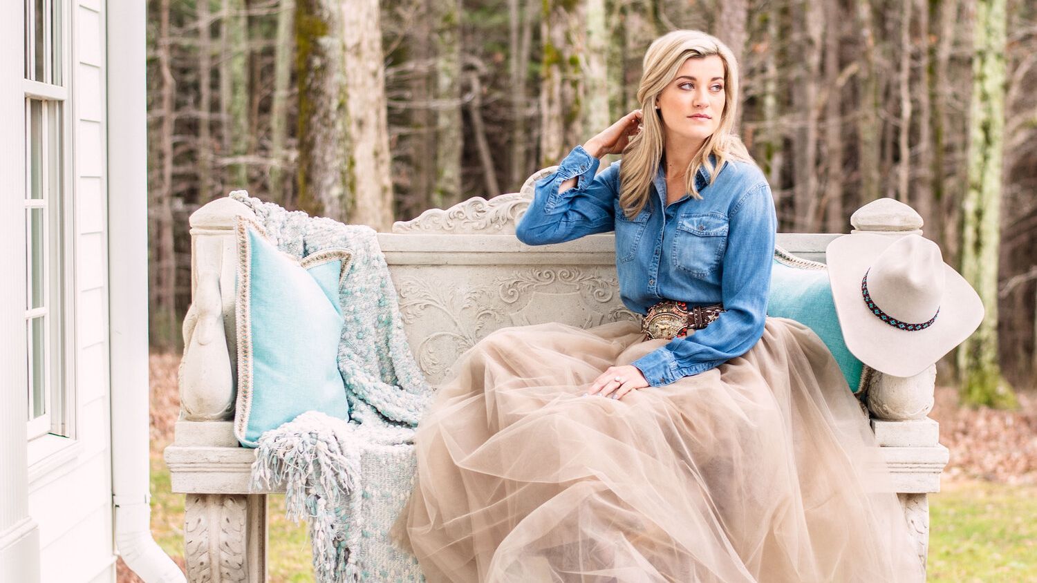 A woman in a tulle skirt is sitting on a bench.