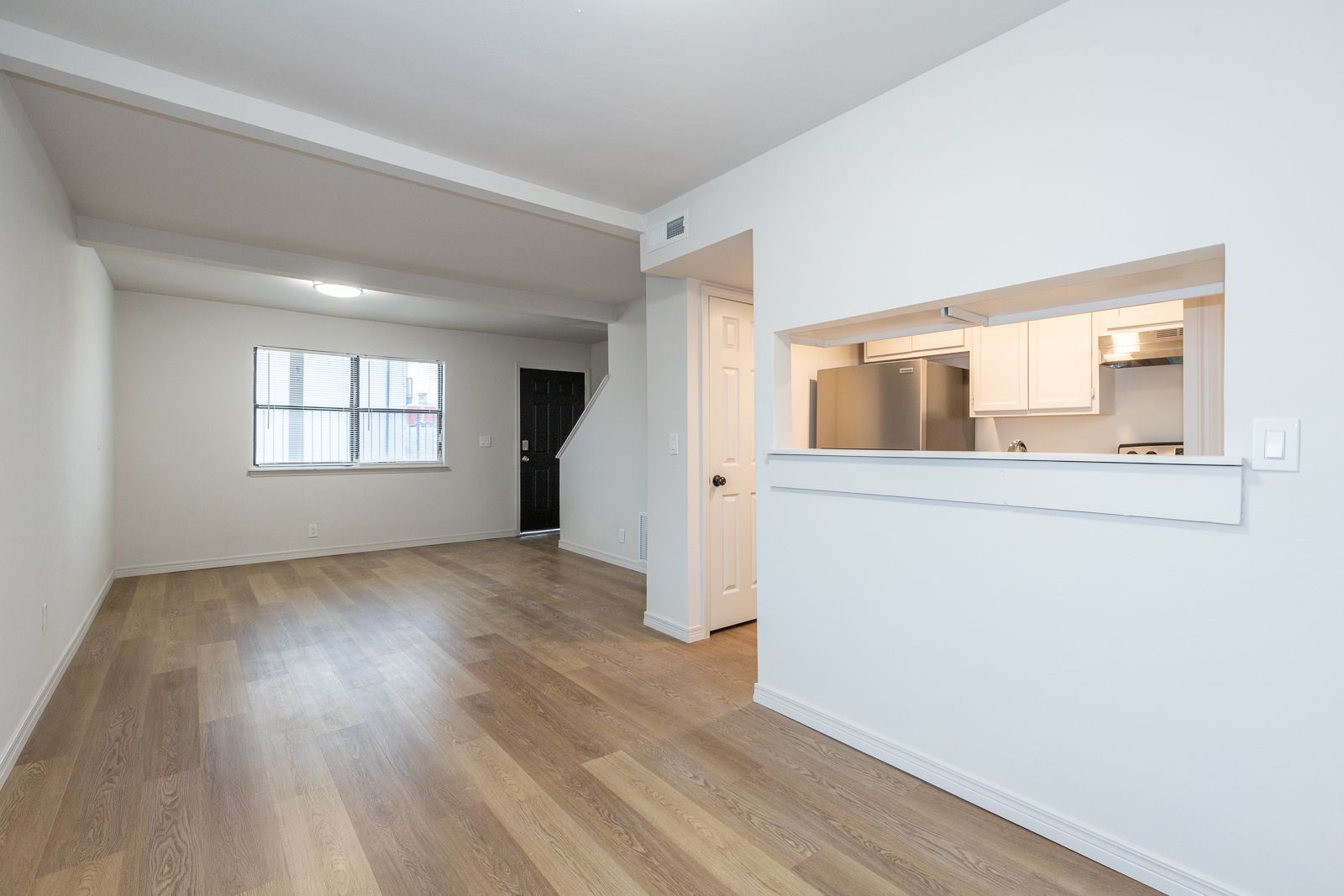 Spacious modern apartment interior at Legacy@23rd in Tulsa, Oklahoma featuring open floor plan, large windows, contemporary finishes, updated kitchen appliances, multifamily apartment community, residential leasing, property management, asset management, long-term apartment rentals, community living.