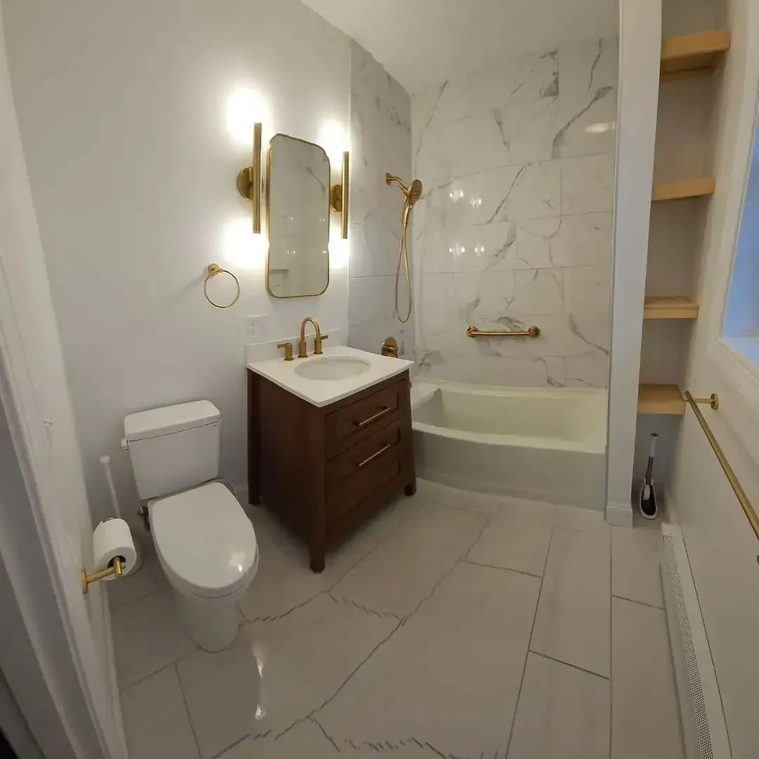 A bathroom with a toilet , sink and bathtub