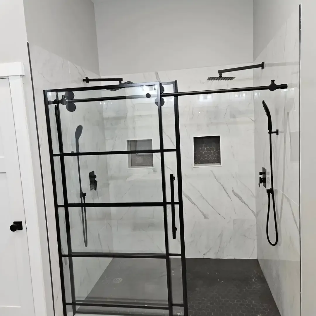 A bathroom with a sliding glass shower door
