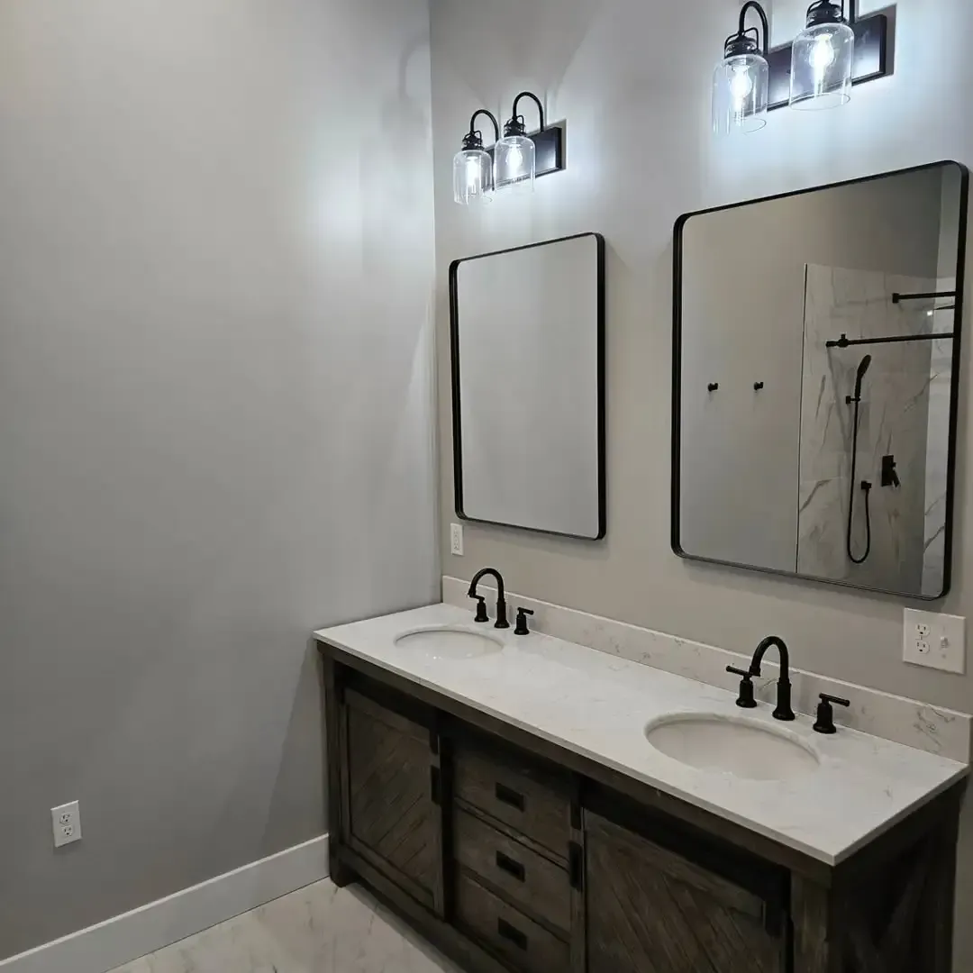 A bathroom with two sinks and two mirrors.