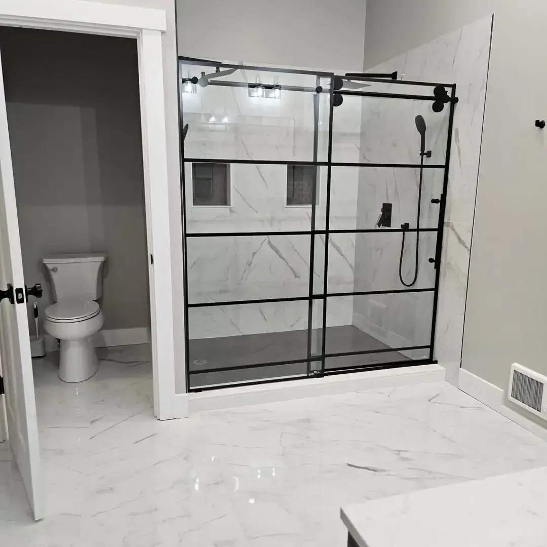 A bathroom with a toilet and a walk in shower.