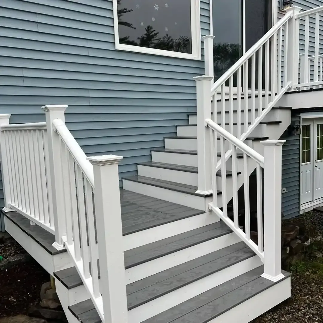 A blue house with white stairs and a white railing