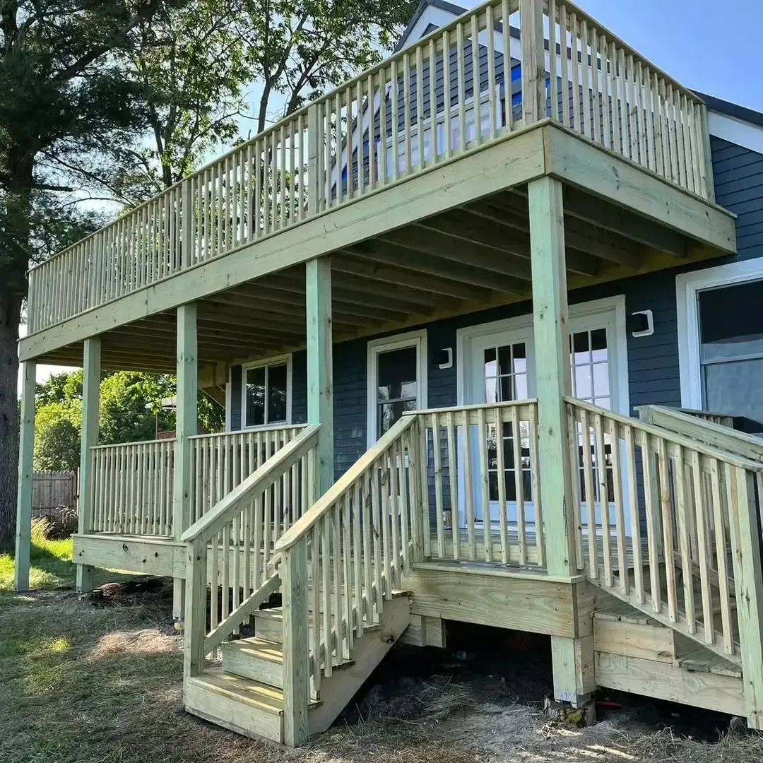 A house with a large wooden deck and stairs.