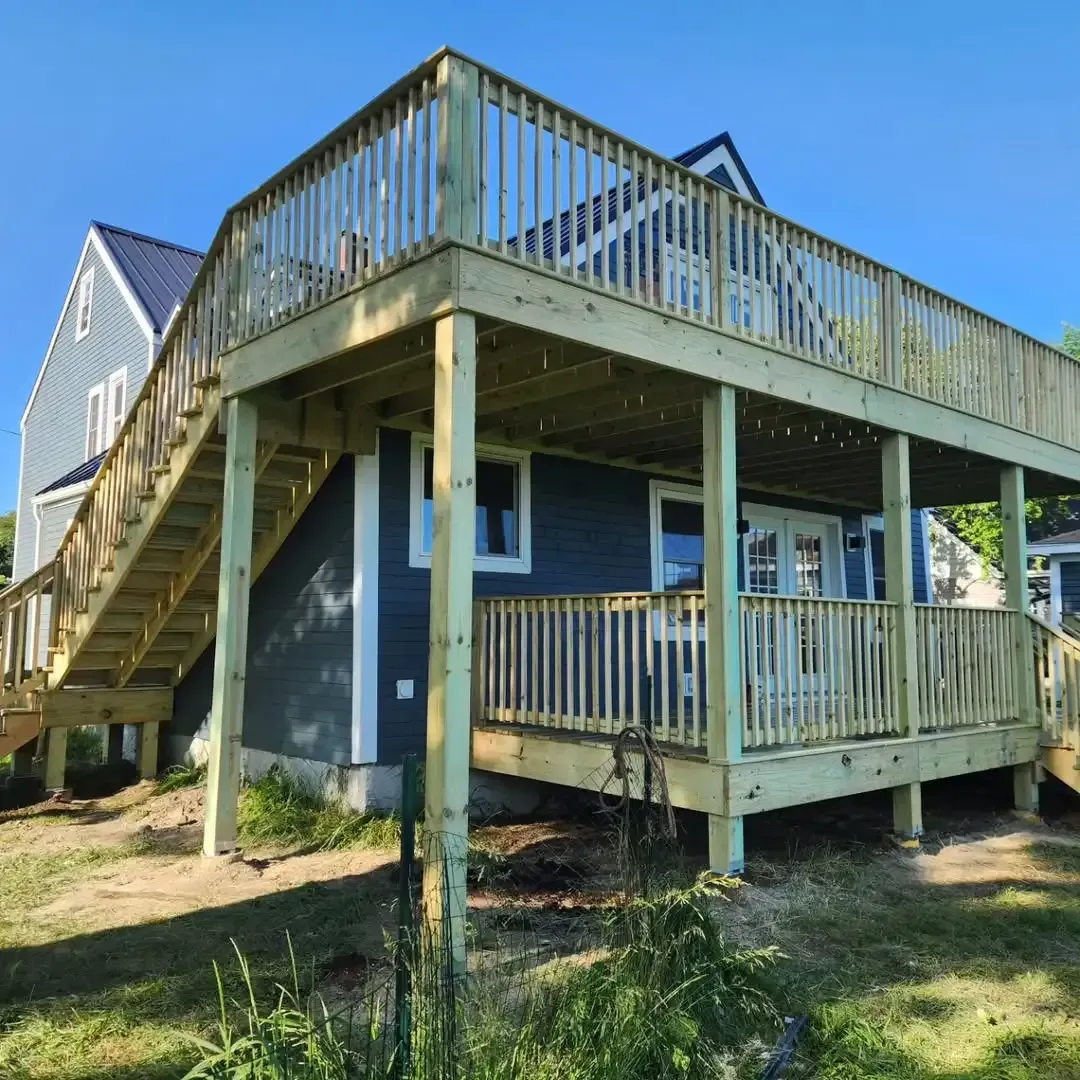 A house with a large deck and stairs leading up to it