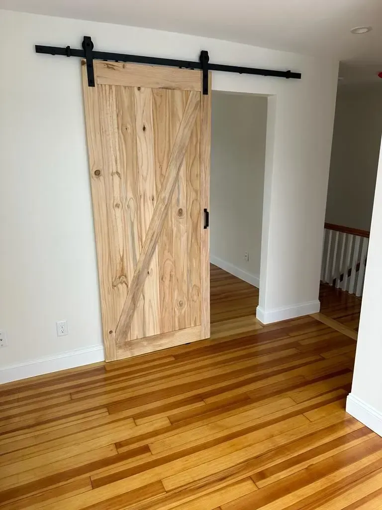 There is a sliding barn door in the middle of the room.