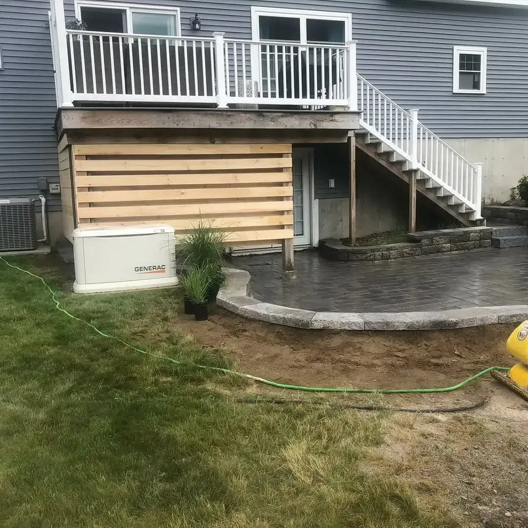 The back of a house with a deck and stairs.