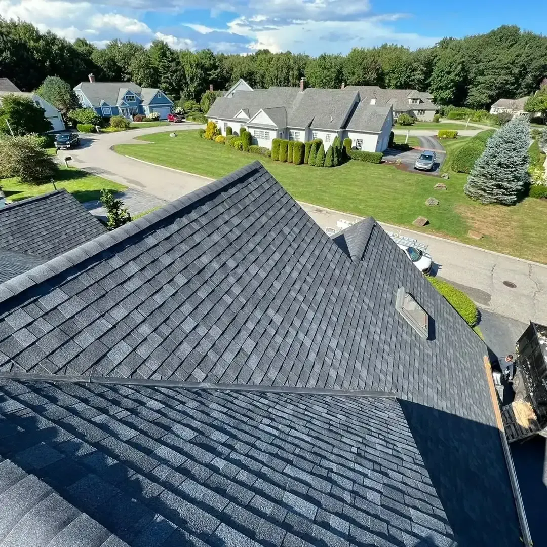 An aerial view of a roof of a house in a residential area.