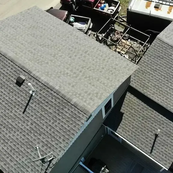 An aerial view of a house with a satellite dish on the roof