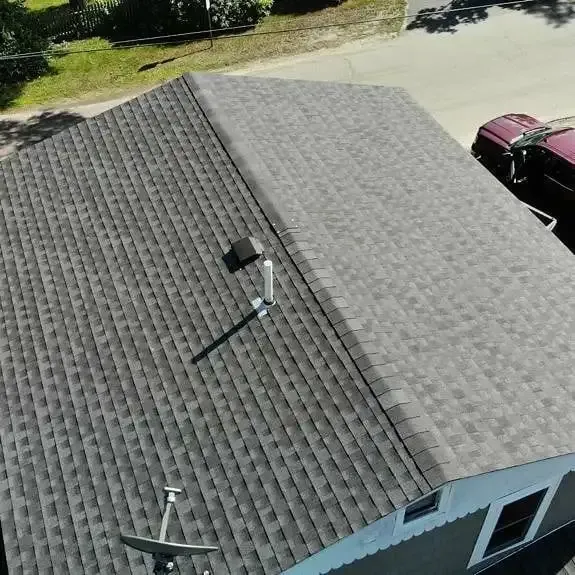 An aerial view of a house with a new roof.