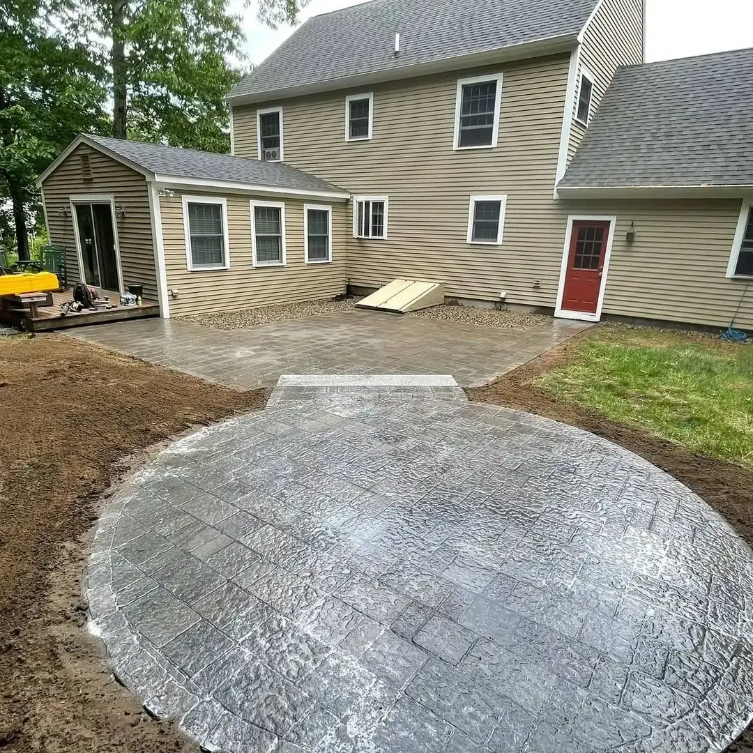 A large house with a circular patio in front of it.