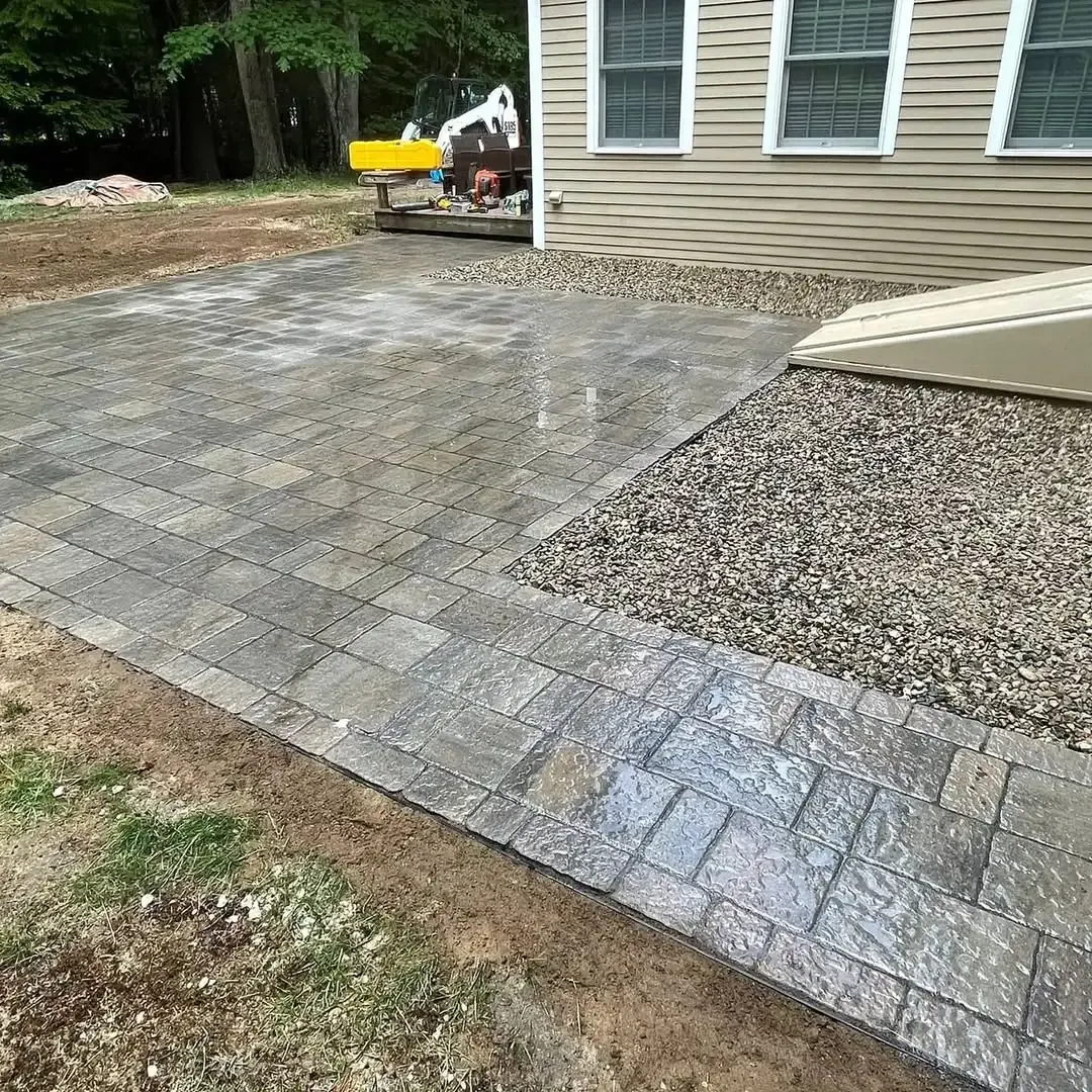 A brick walkway is being built in front of a house.