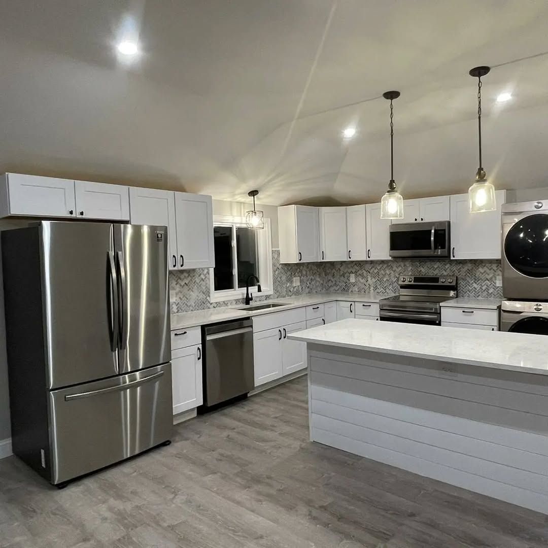 A kitchen with stainless steel appliances and white cabinets
