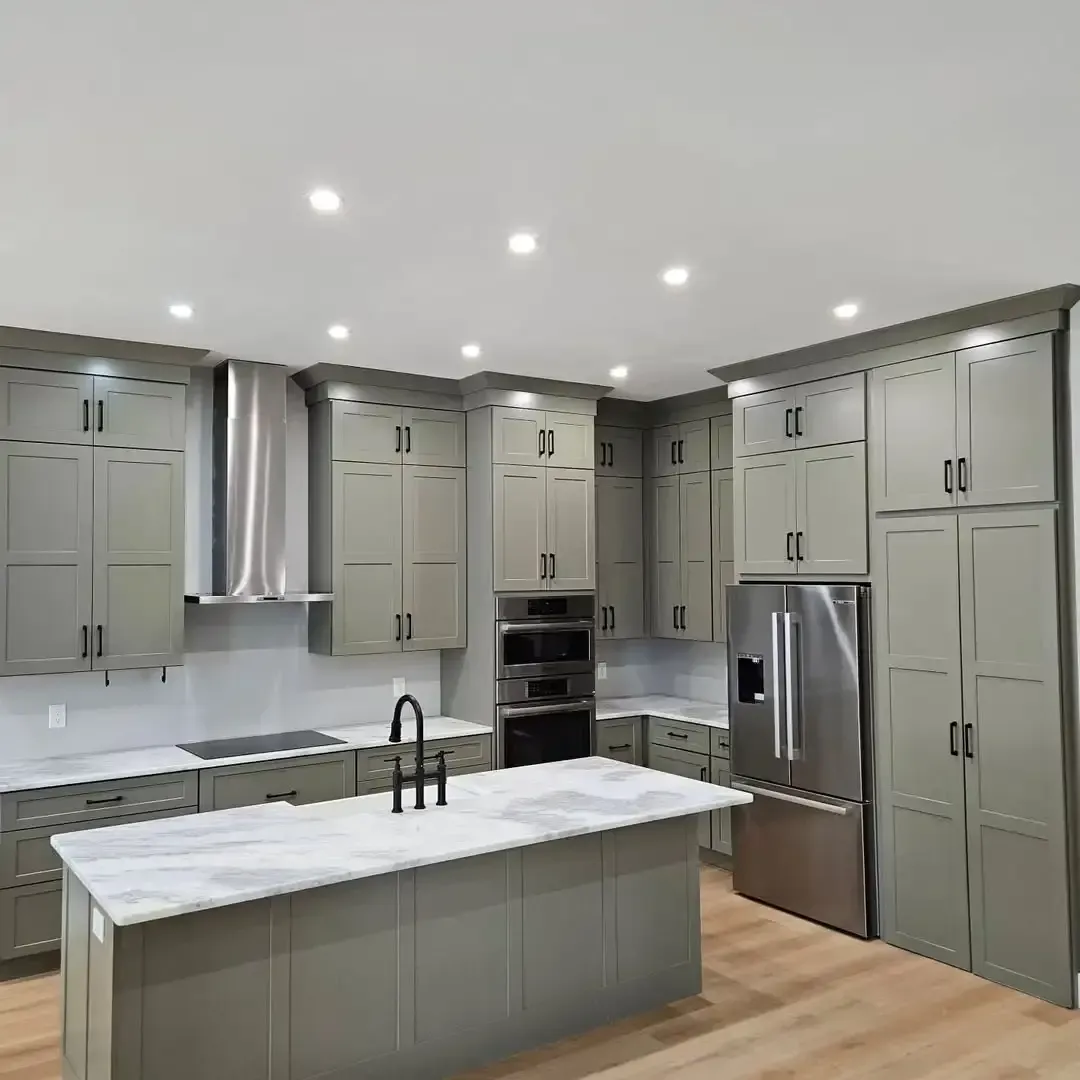 A kitchen with a large island and stainless steel appliances
