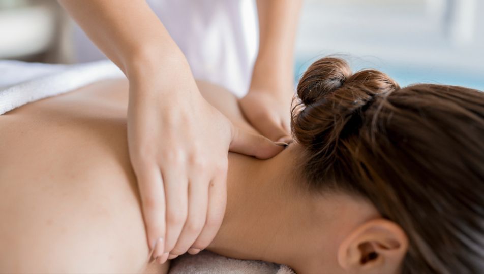 Hands giving neck and shoulder massage.
