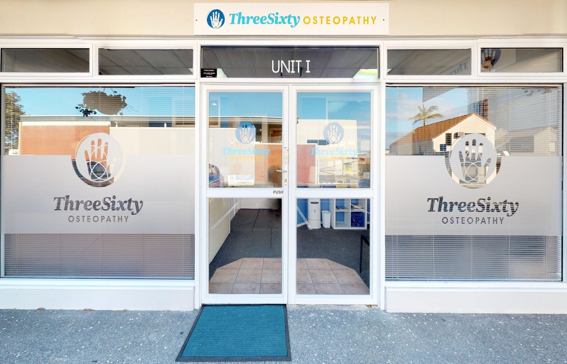ThreeSixty Osteopathy clinic storefront with frosted logo on glass doors and windows.