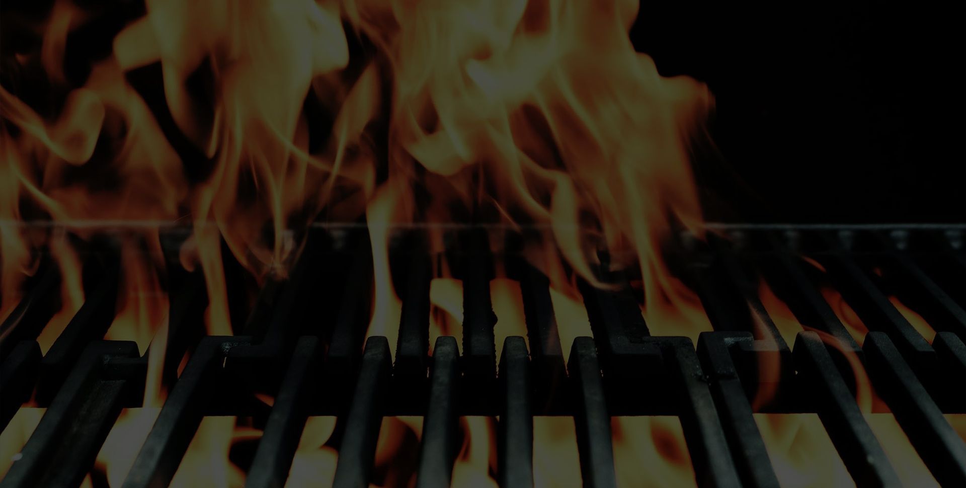 Flames rising over piano keys, showing a piano on fire