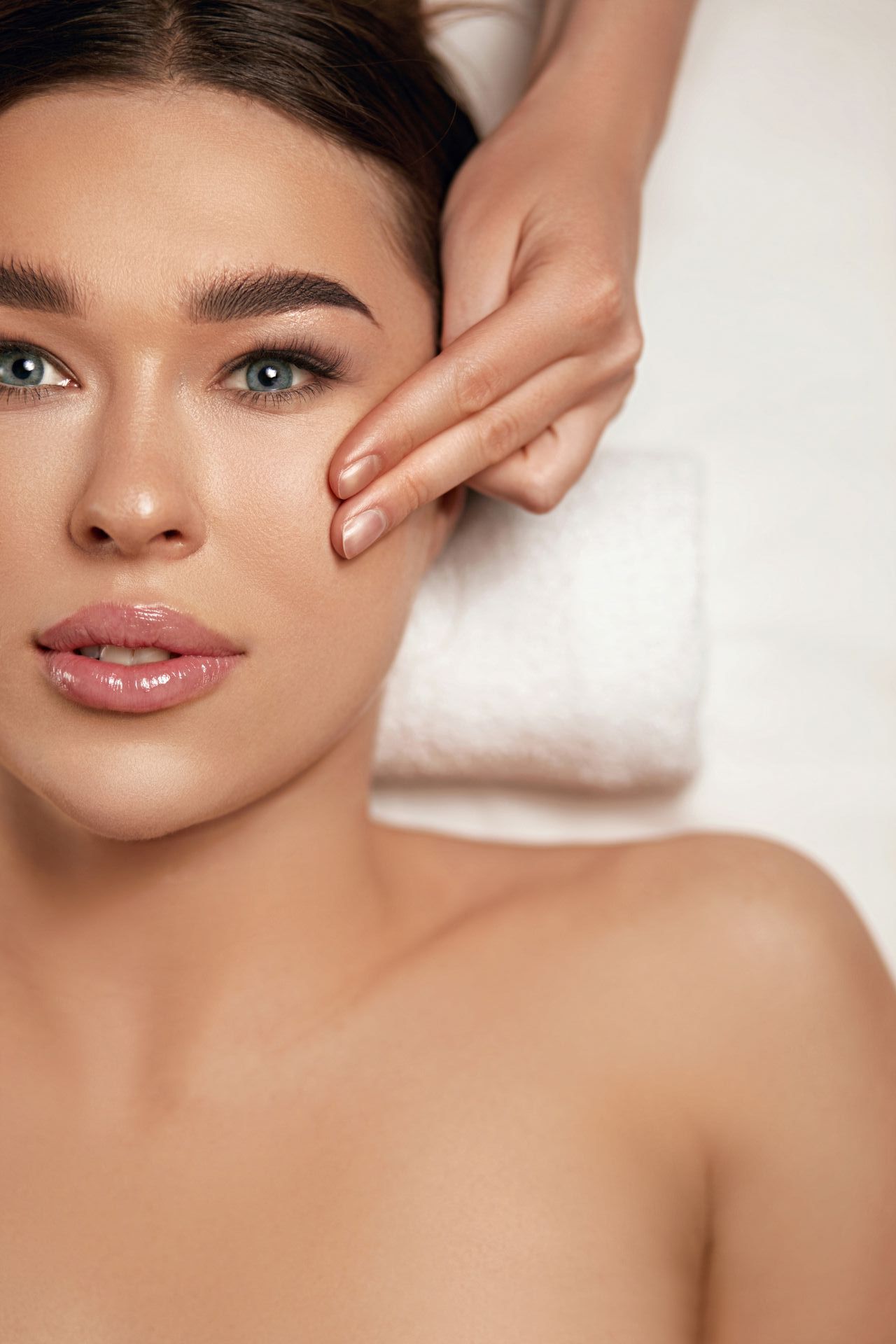 a woman is getting a facial massage at a spa .