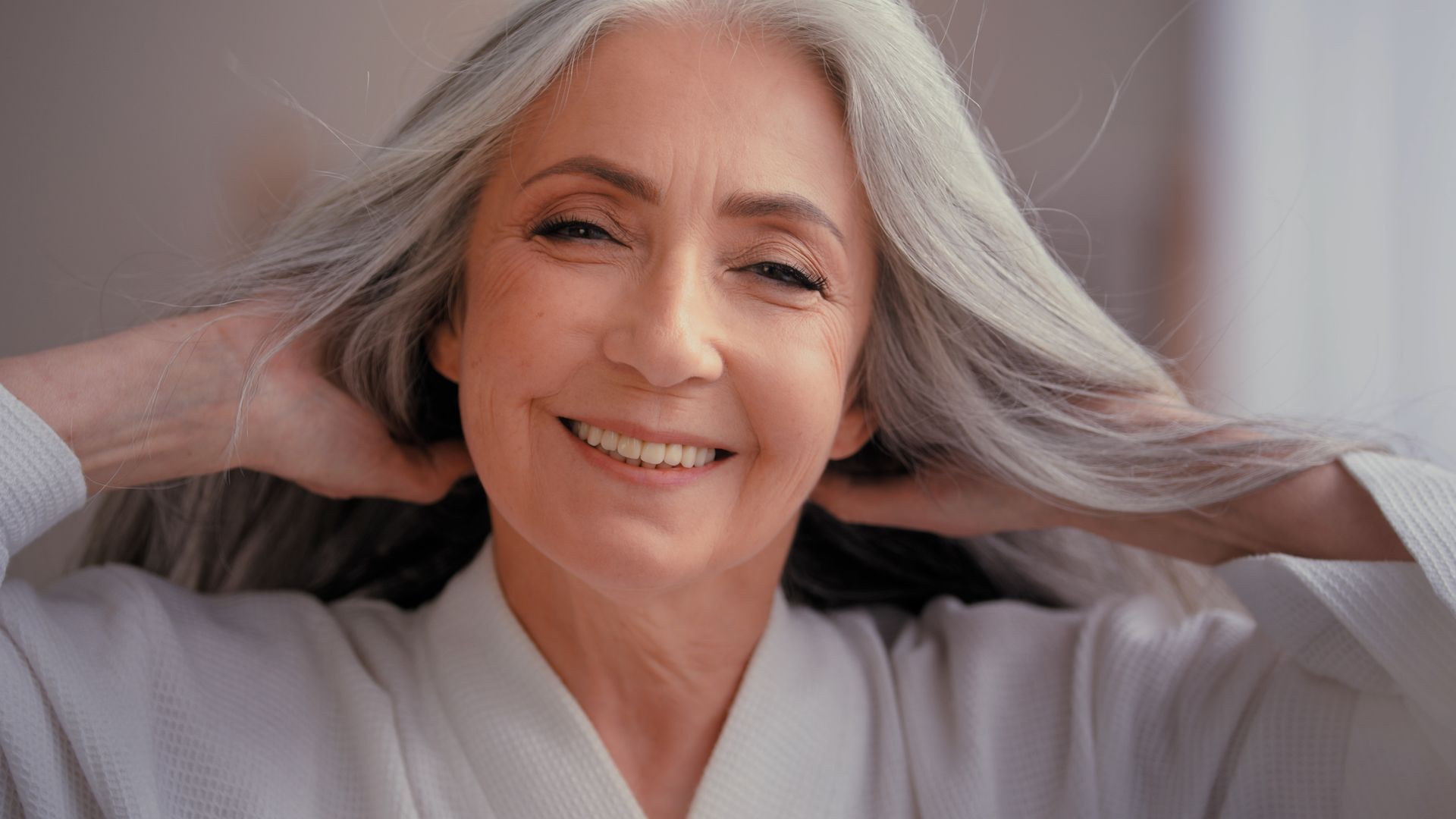 smiling middle aged woman with grey hair