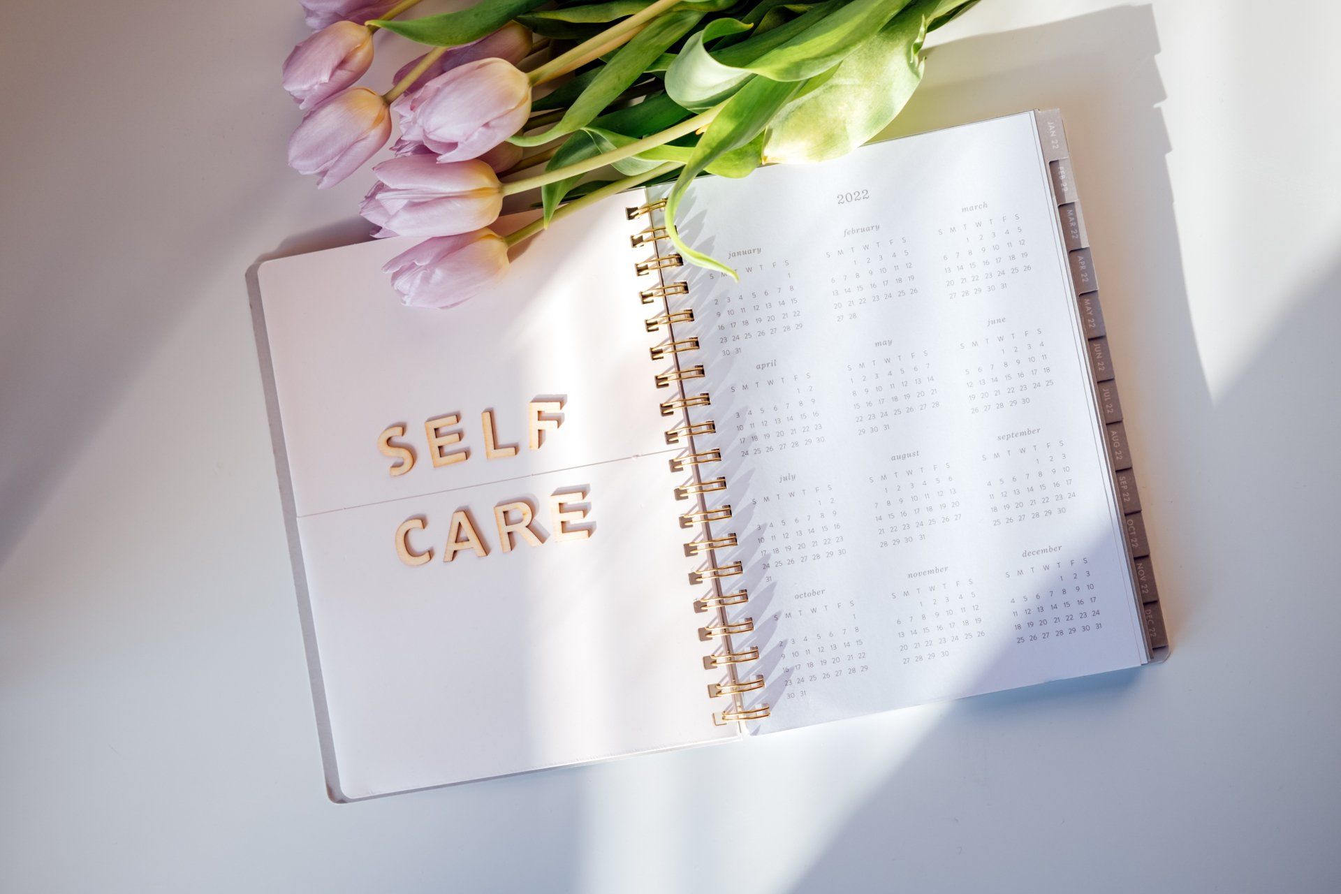 calendar notebook with self care in letters