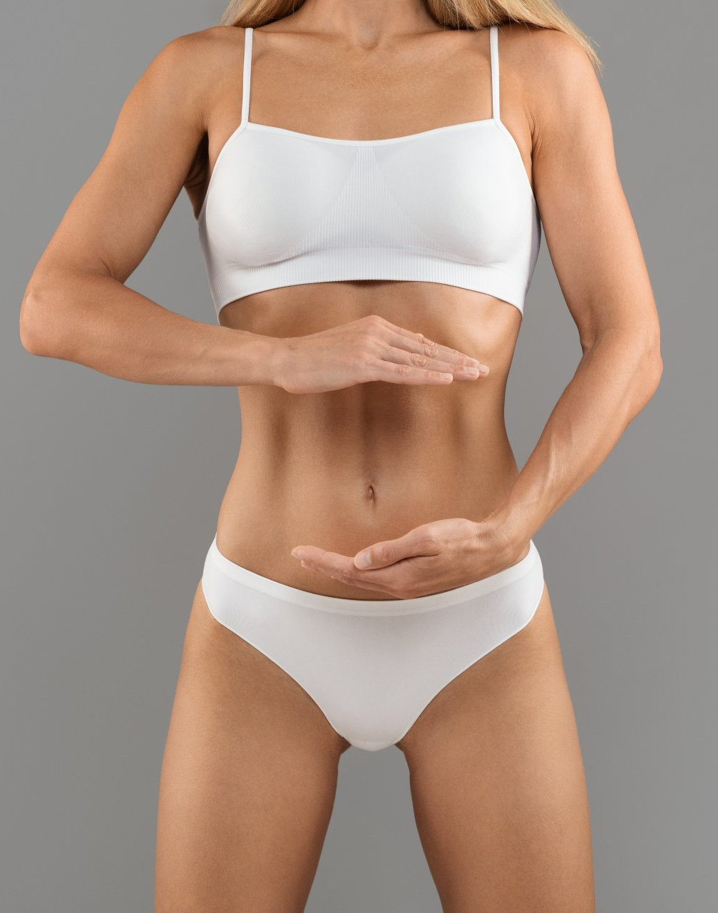 fit female in underwear holding invisible object