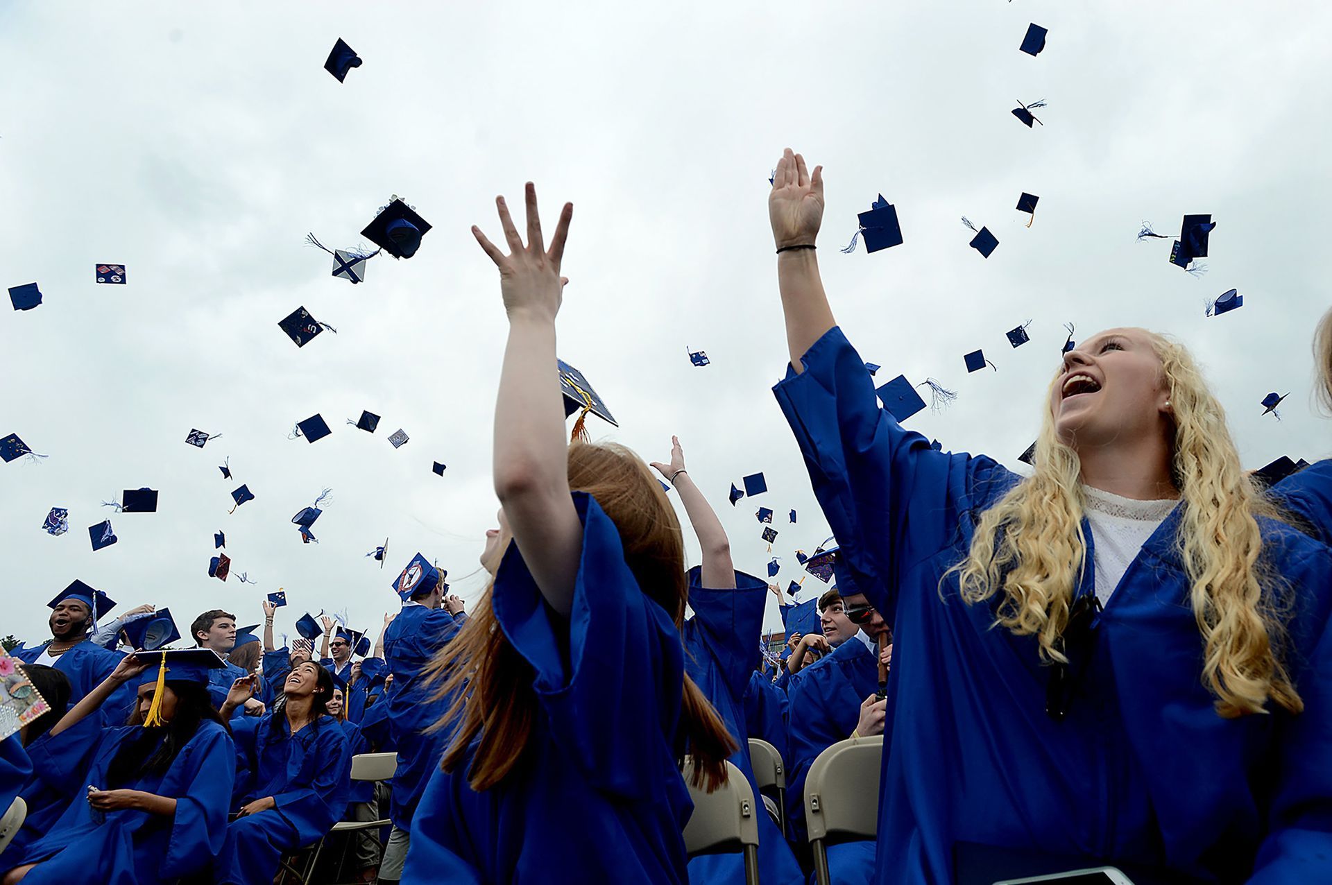 Lincoln-Sudbury graduates toss their caps in the sky at the conclusion of graduation ceremonies at the high school Sunday, June 4, 2017.