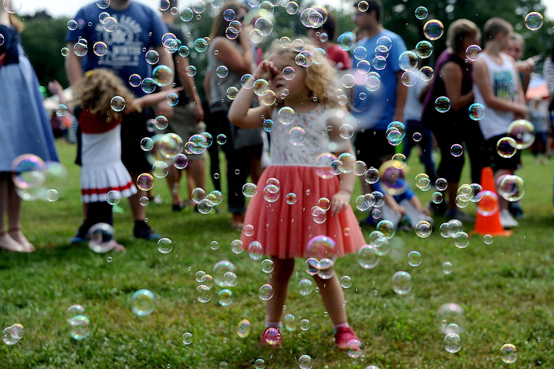 Julia Shannahan, 3, of Hopedale, is surrounded by bubbles from DJ Mike Rutkowski during the 39th annual Hopedale Day in the Park Saturday, Sept. 15, 2018.