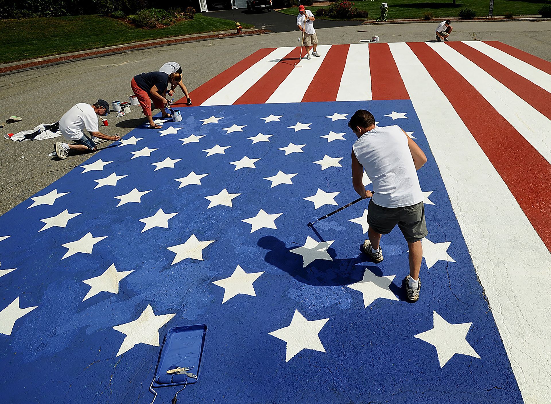 Residents of Alan Rd. in Hudson paint an American flag at the end of their cul-de-sac on Sept. 9, 2011 in preparation for the tenth anniversary of the terrorist attacks of 9/11.