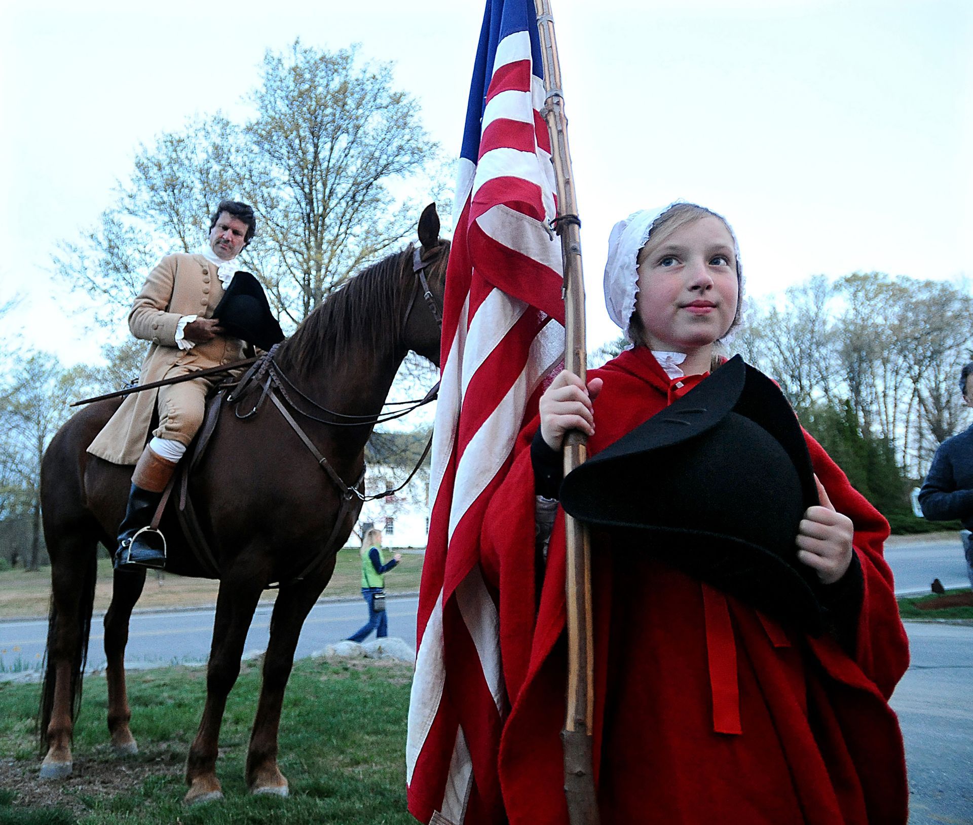 Natalie Brown, 11, of Sacramento, California, takes part in the benediction during Patriots Day ceremonies in Sudbury, April 19, 2012.