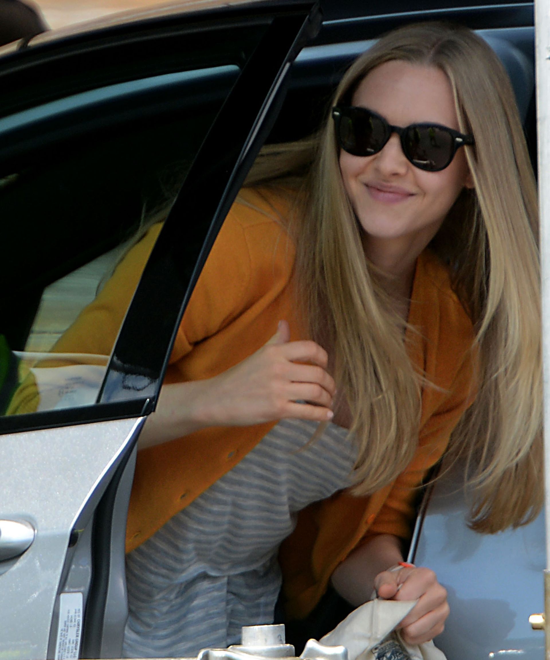 Amanda Seyfried gets out the car she was driving for a scene for “Ted 2” at the Mass Pike Framingham Plaza, Aug. 14, 2014.