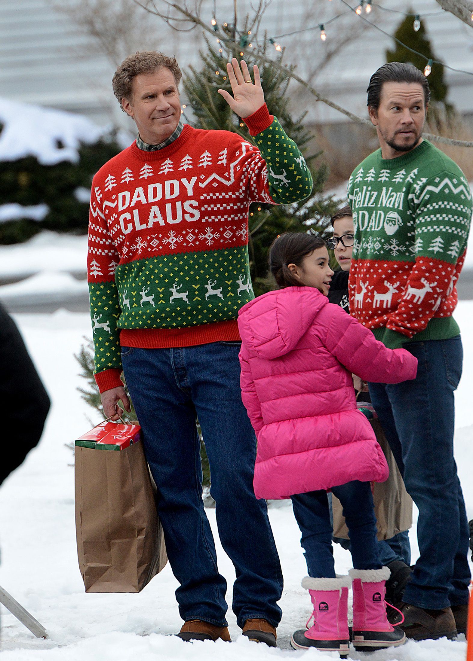 Will Ferrell waves as he and Mark Wahlberg and a pair of child actors prepare to film a scene for