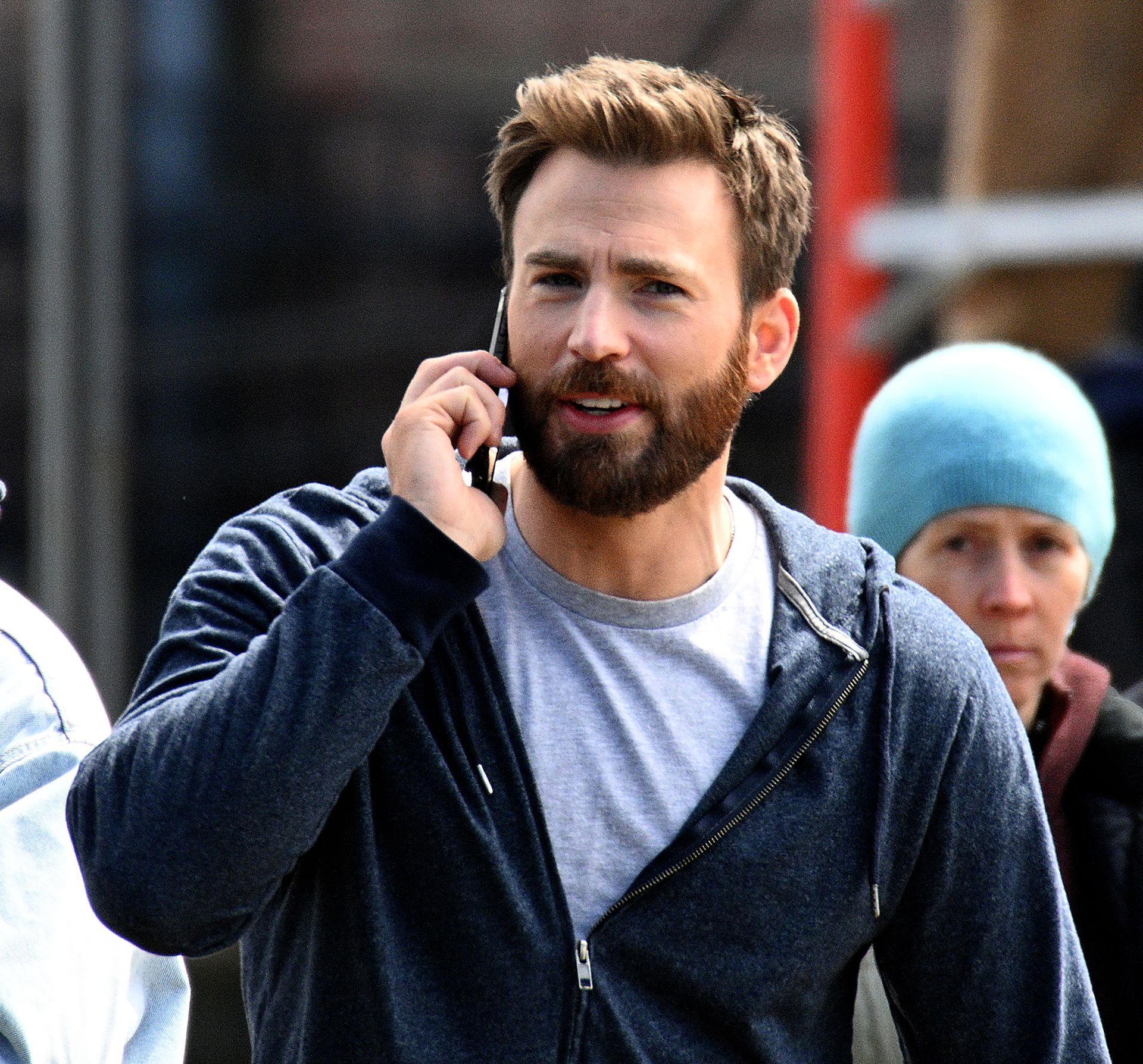 Chris Evans, famous for playing Captain America in the Marvel movies, talks on the phone in between shooting scenes on Natick Common for the Apple TV+ series “Defending Jacob,” April 11, 2019.
