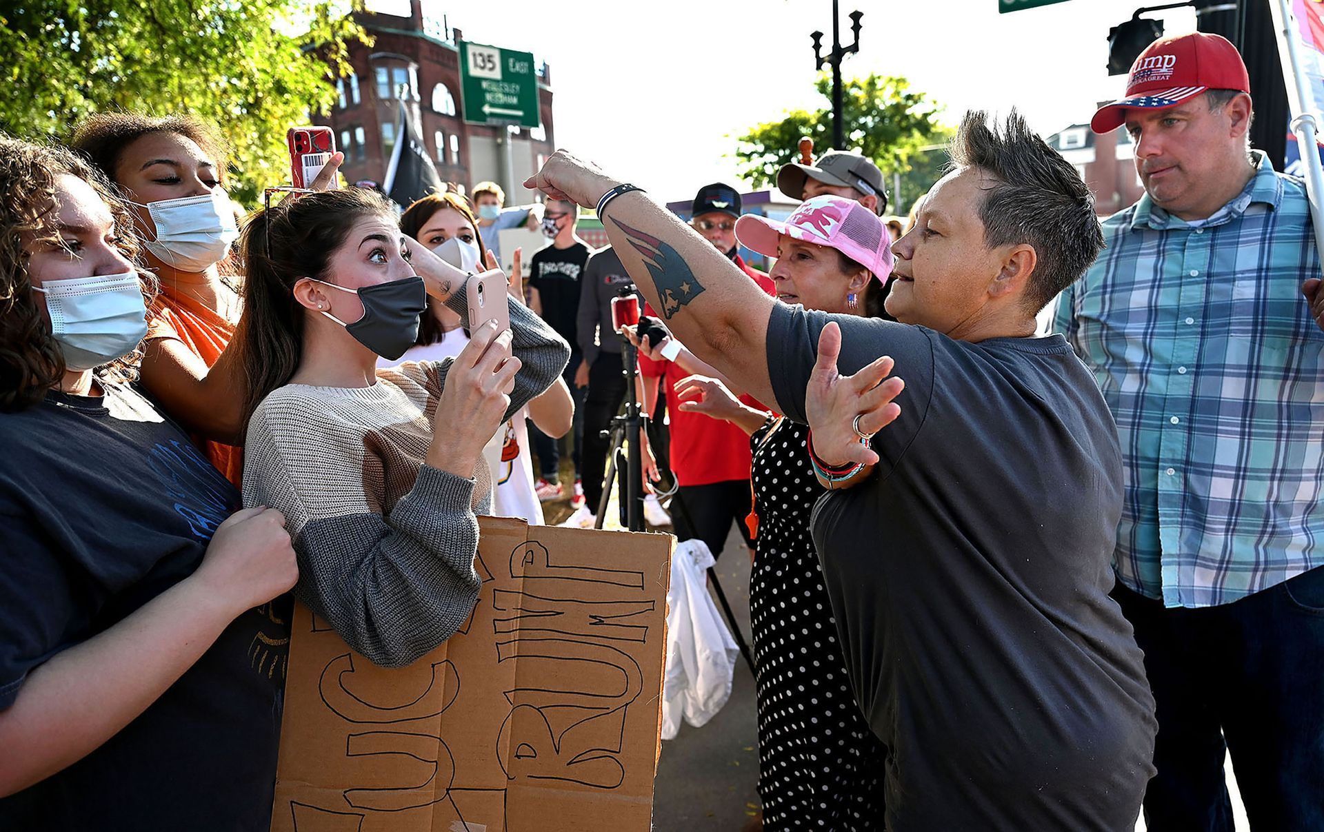 President Trump supporter Jessie Morgan of Nashua, New Hampshire, right, points her finger at counter protester Keilah Lopes, 17, of Natickduring a heated exchange on Natick Common on Saturday, Sept. 26, 2020.