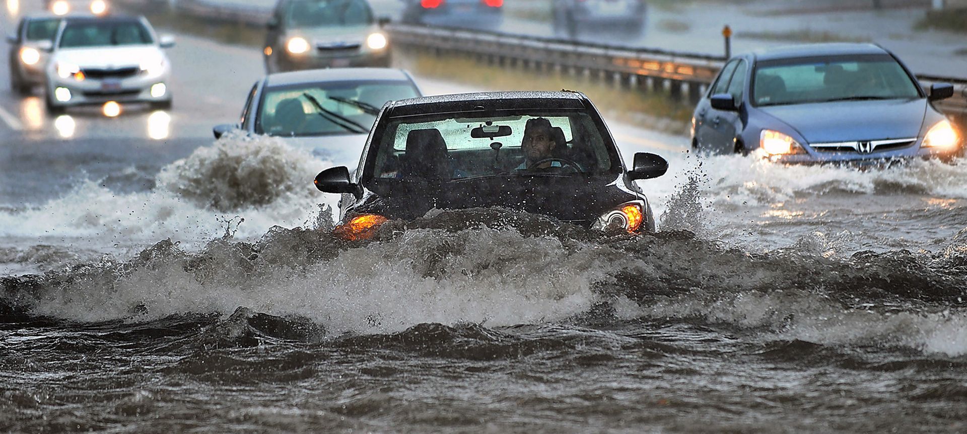 Motorists try to negotiate deep water on Rte. 9 west underneath an overpass in Framingham, Massachusetts, as heavy rain from the remnants of Hurricane Florence causes flash flooding, on Tuesday, Sept. 18, 2018.
