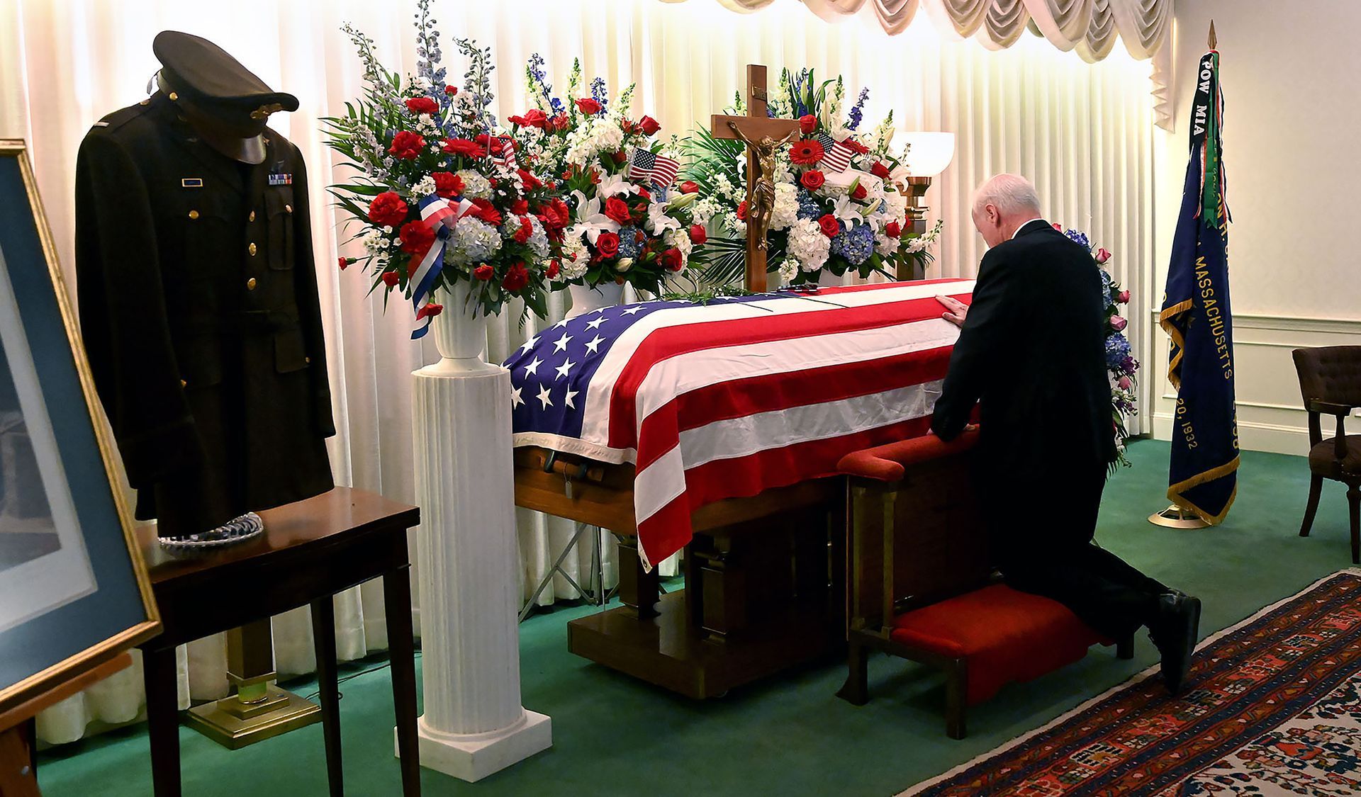 Bill Glennon of Quincy puts his hand on the casket of his uncle, 1st Lt. Joseph Finneran, a Needham native who was killed during World War II and whose remains were only recently identified, at the George F. Doherty and Sons Funeral Home in Needham Saturday November 9 2019. Lt. Finneran's funeral came after a 70-year-long investigation by the U.S. Army.