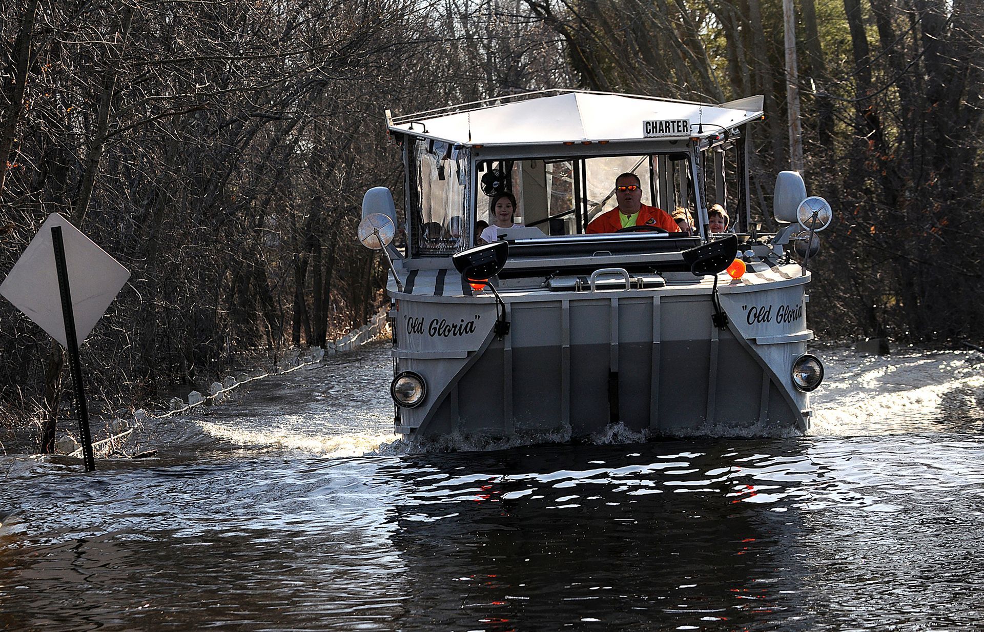 A Boston Duck Tours amphibious vehicle ferries home residents of Pelham Island Road in Wayland after floodwaters from the Sudbury river made their neighborhood inaccessible on March 17, 2010.
