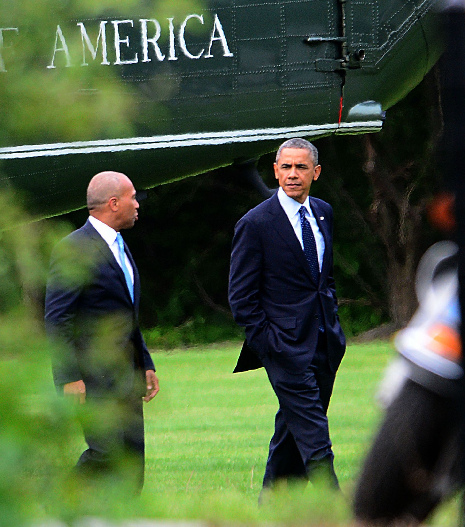President Barack Obama walks to his limousine with Gov. Deval Patrick after a helicopter landing at Weston Middle School, June 11, 2014. President Obama was in town for a private fundraiser.