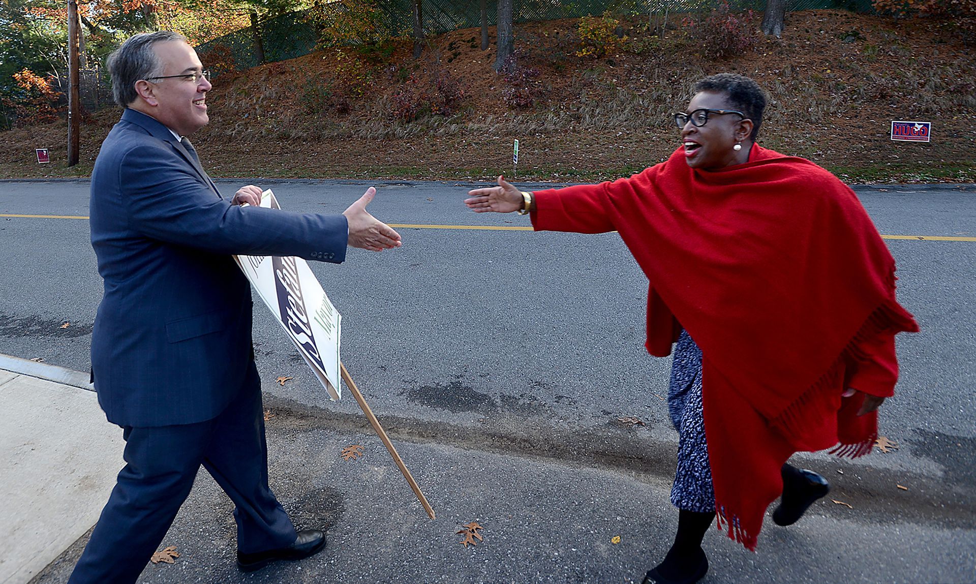 Opposing Framingham mayoral candidates John Stefanini, left, and Yvonne Spicer meet briefly to shake hands at the George King Elementary School polling station on election morning, Tuesday, Nov. 7, 2017.