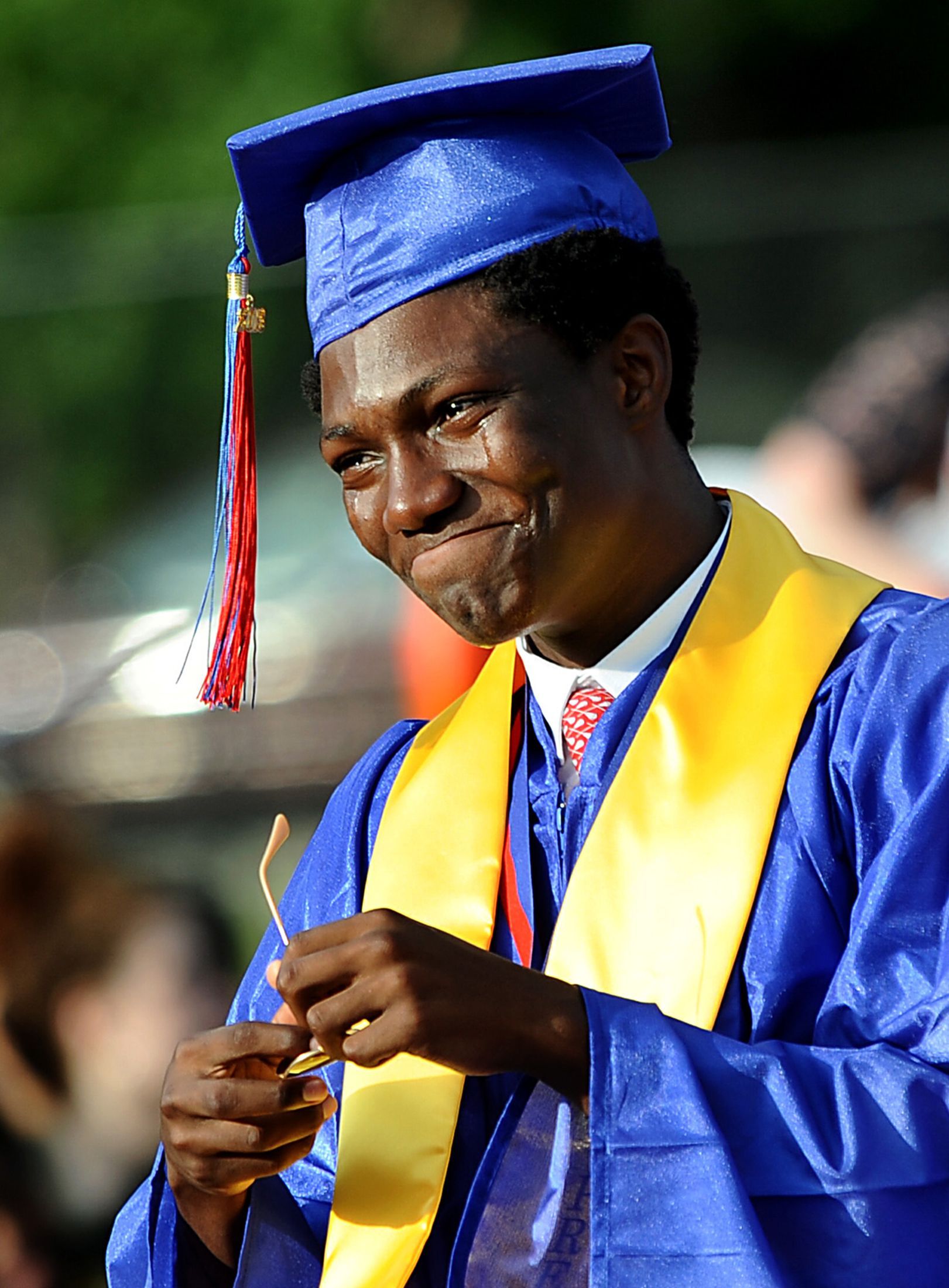 Natick High School Class of 2018 president Dishod Kirby sheds tears of pride after his commencement address Friday, June 1, 2018 at Memorial Field. Natick High was his fourth high school when he arrived as a junior.