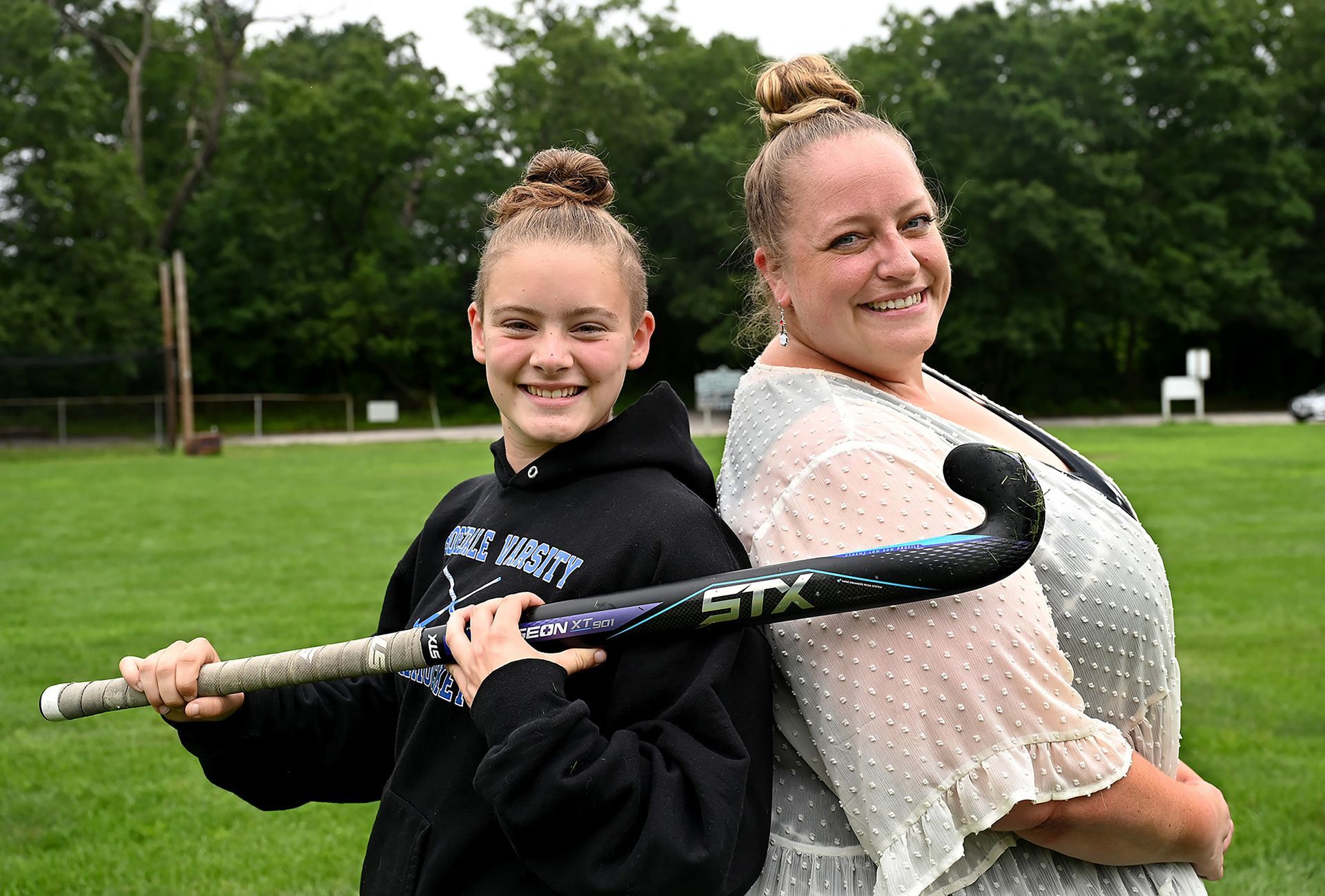 Hopedale field hockey and softball player Alyssa MacNeil, left, and her mother Suzanne, have more in common than their matching buns. Alyssa wears the same uniform number her mother wore when her mom played softball for the Blue Raiders. (7/14/21)