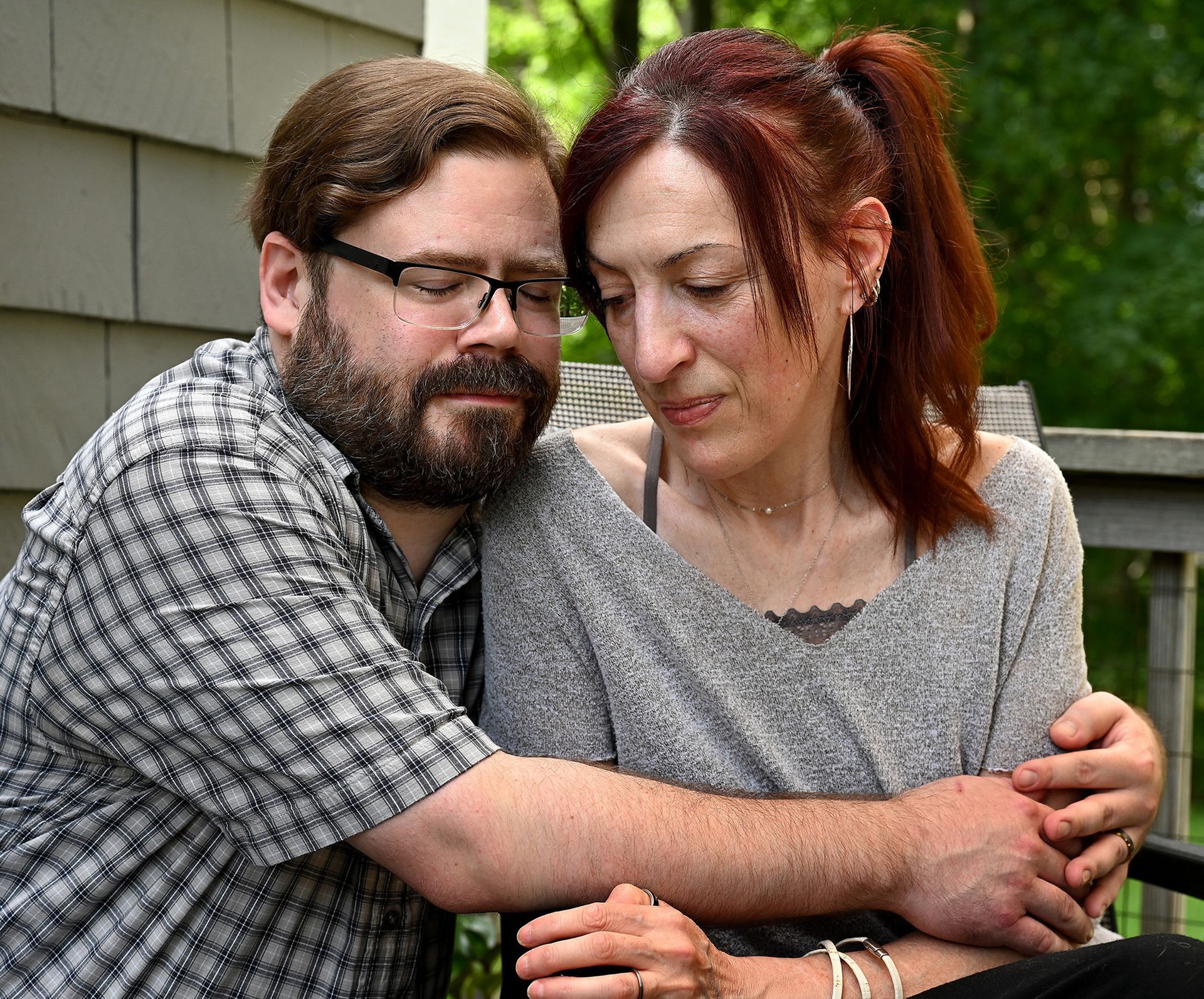Andrew Colbert hugs his wife Kimberly Gunner, August 12, 2021, almost exactly a year after the August 18, 2020 hit-and-run crash that injured the Natick couple, leaving Gunner with severe injuries that she is still recovering from. The couple have received an outpouring of support from Natick and beyond in the last year. T