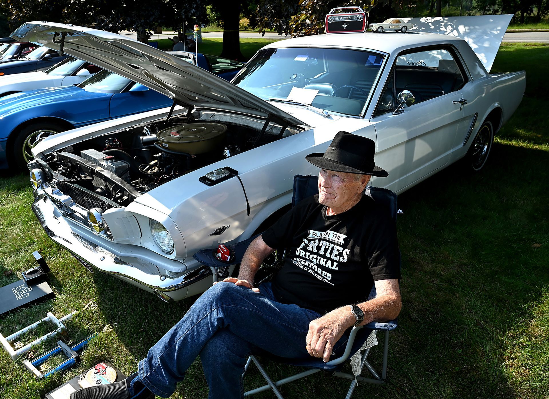 Wes Delano of Framingham sits by his 1965 For Mustang during the 9th annual Kidde Fenwal Car Show at the Kidde Fenwal Company in Ashland, Sept. 10, 2022.