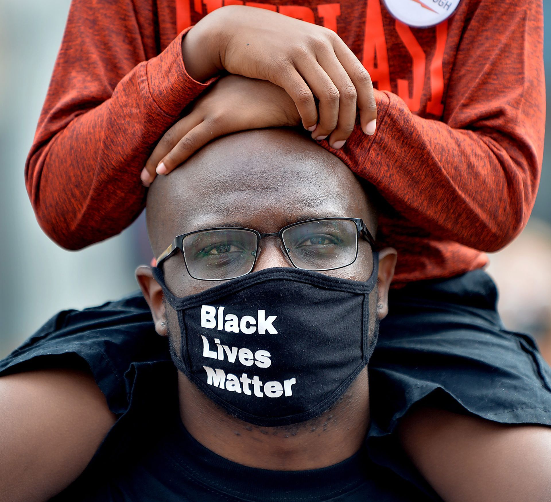 Mike Joseph of Marlborough, with his son Nathaniel, 8, attends a rally in support of the late Eurie Stamps Jr., a Black man who was killed in his home by police during a SWAT raid in January 2011, during a rally in support of reopening the Stamps' case, on Saturday August 15.