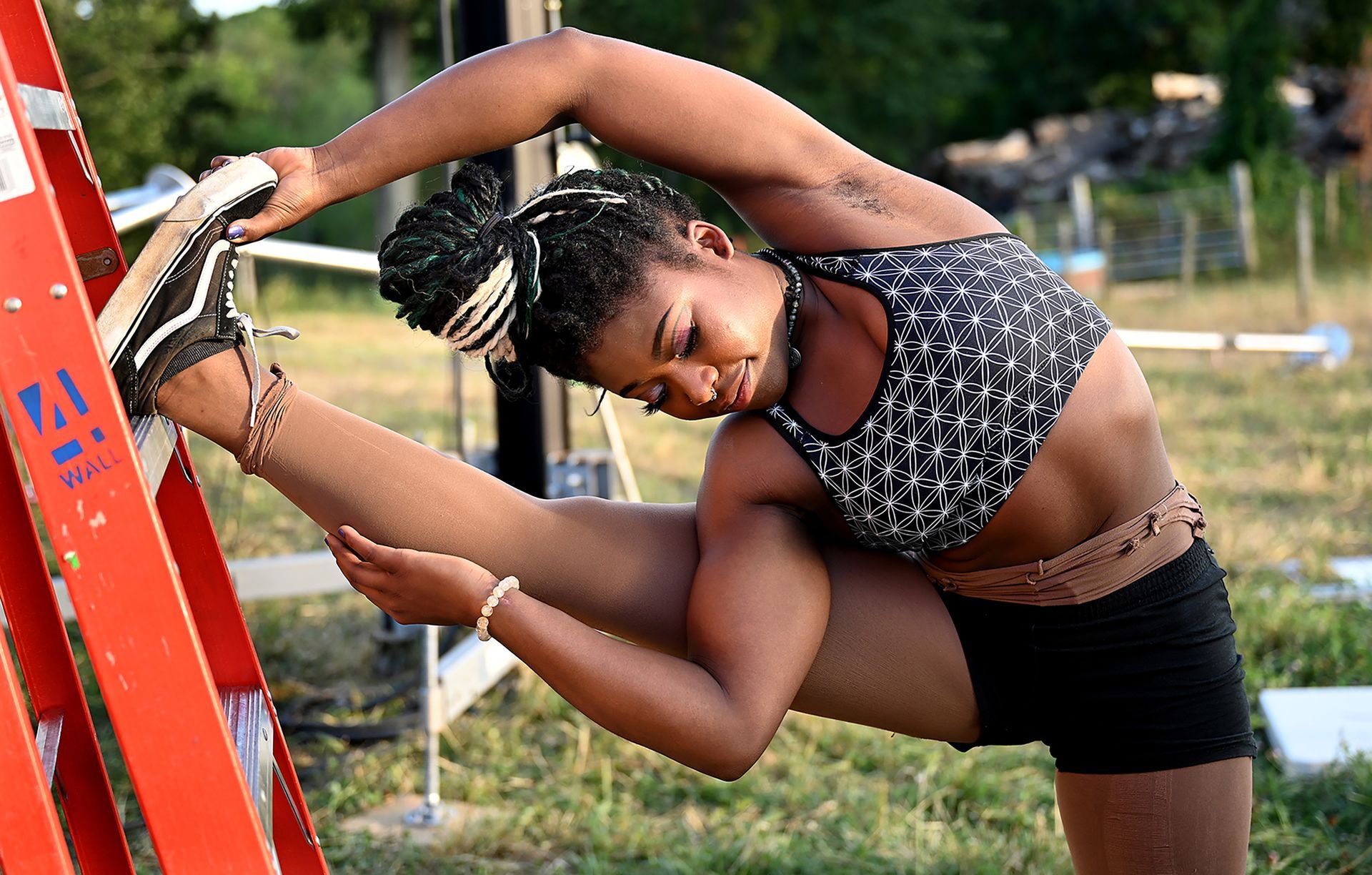 Trapeze artist Julia Baccellieri stretches before an evening performance of Stars Above, an open air circus on a circular stage that combines contemporary and classical circus, at Eastleigh Farm in Framingham, August 12, 2022.