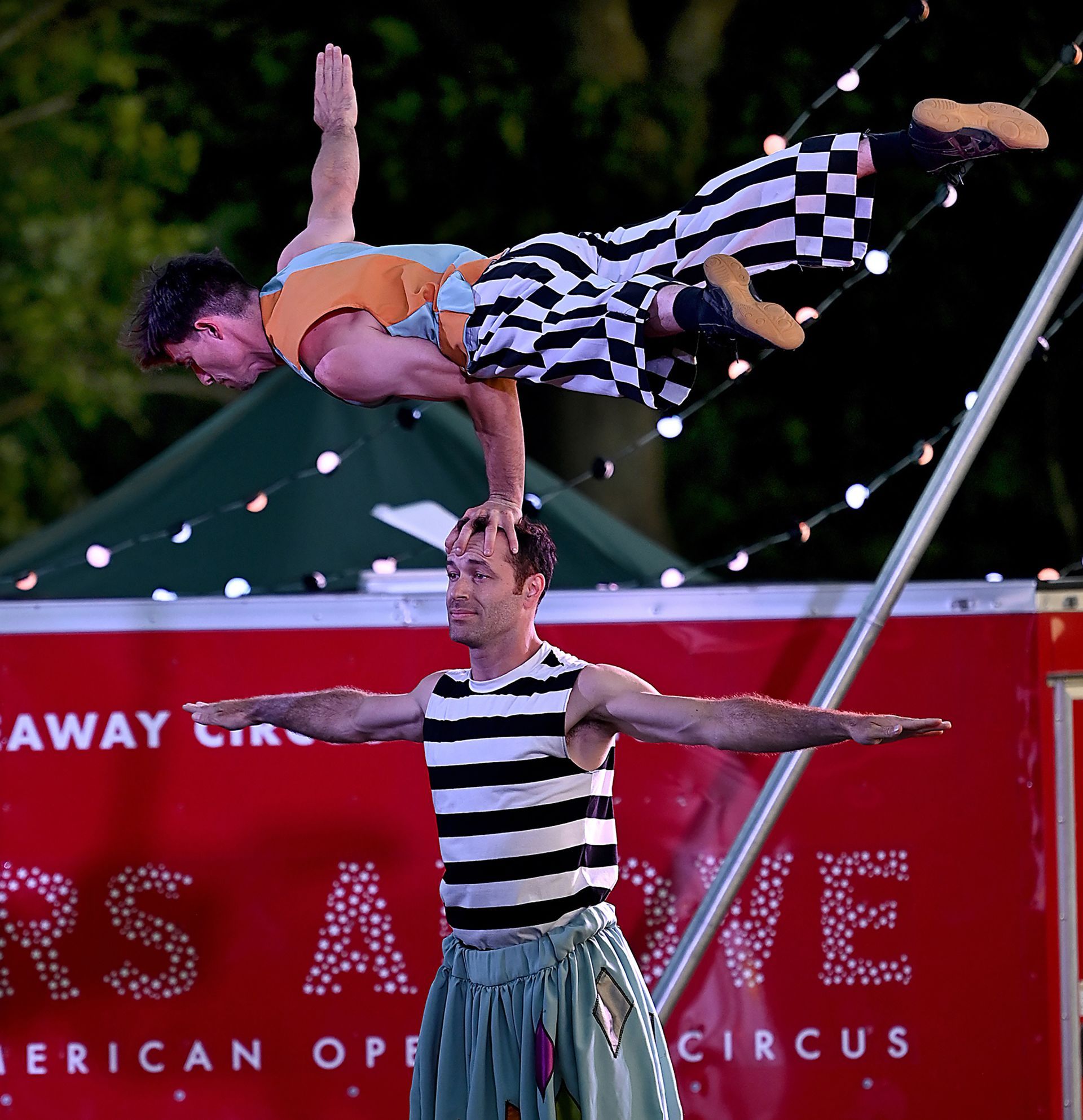 For a moment, a Hideaway Circus performer balanced on a fellow artist's head during an en evening performance of Stars Above at Eastleigh Farm in Framingham, August 12, 2022.