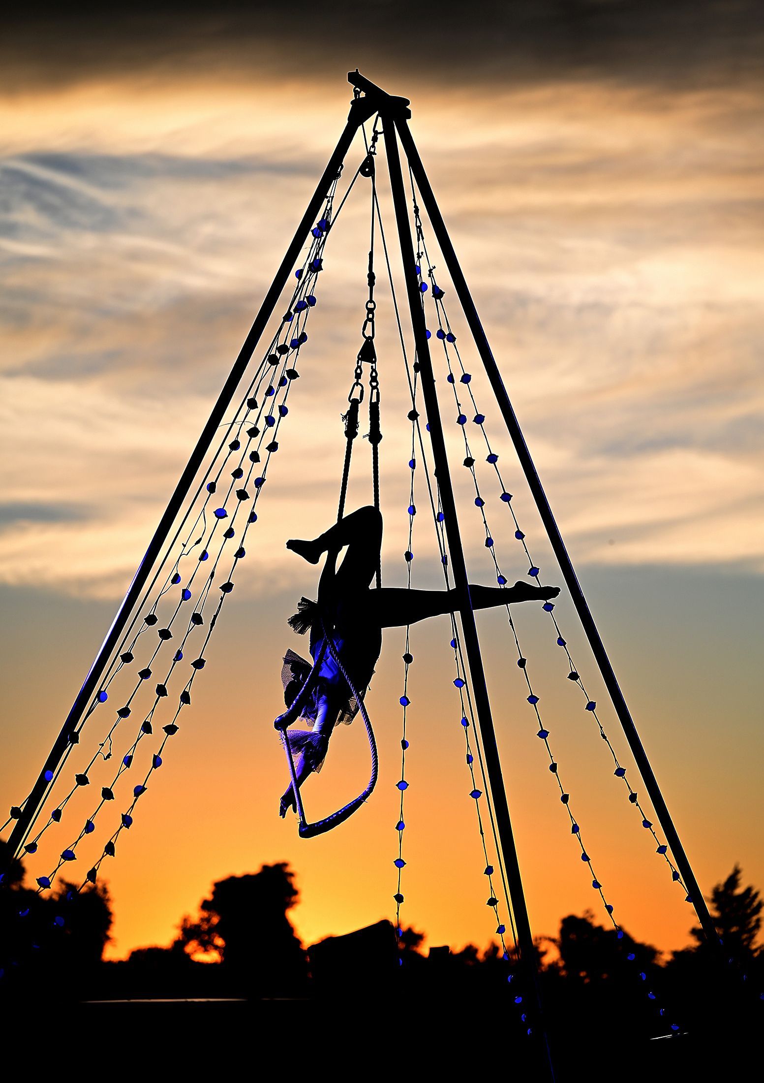As the sun sets at Eastleigh Farm in Framingham, aerialist Julia Baccellieri wows the audience, August 12, 2022.
