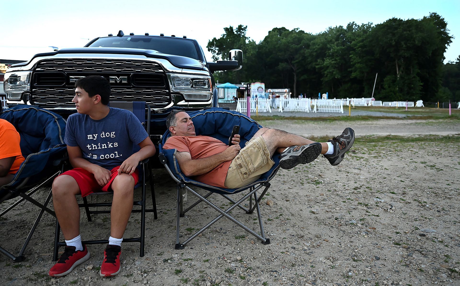 Gary Barboza of Westport makes himself very comfortable while waiting with his son Gareth, 15, for